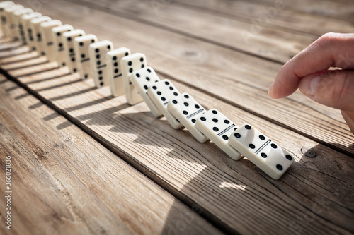 Stop the domino effect concept for business solution and intervention photo