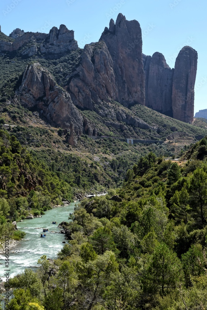 rafting in a river surrounded by mountains