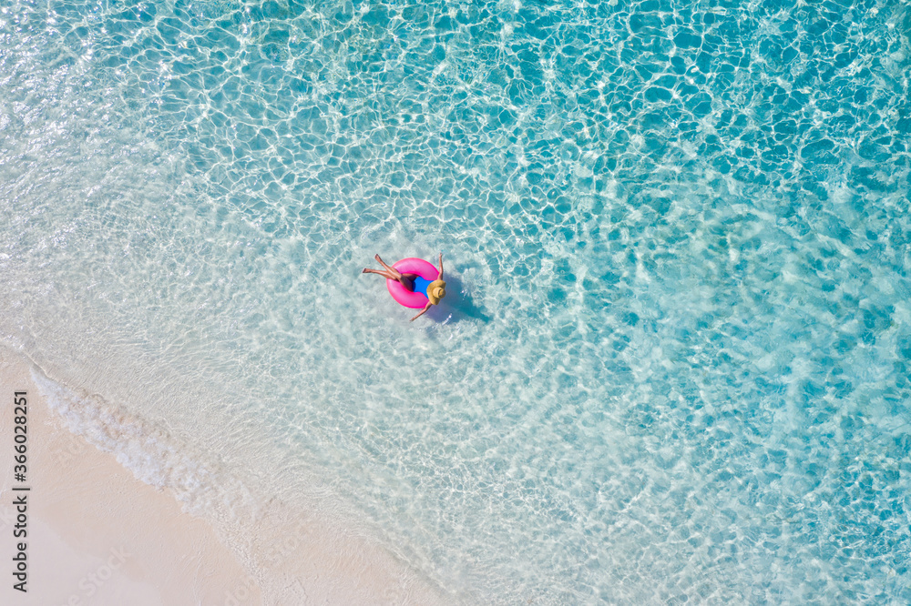 Top above high angle aerial drone view of her she attractive girl floating on rubber ring ocean clear water leisure enjoy joy day daydream relax sunny hot weather destination