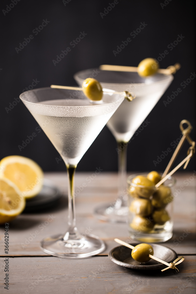 2 glasses of martini with olives. On a wooden background. Portrait 2 glasses of martini with olives. On a wooden background. Portrait
