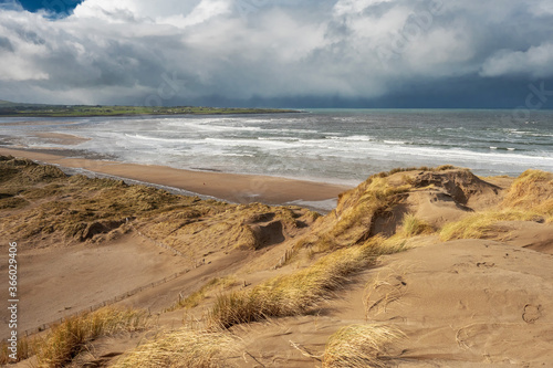 Fototapeta Naklejka Na Ścianę i Meble -  View from a top of a dune on Strandhill beach, county Sligo, Ireland. Atlantic ocean, Blue cloudy sky.