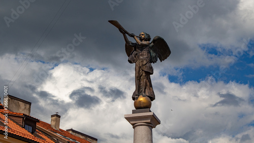 A statue of an angel on a square in the old town of Vilnius. Angel. Cloudy sky photo