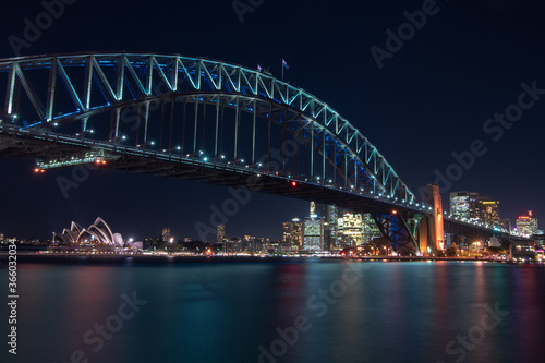 Sydney harbour bridge illuminated in blue at night © Susanne Warlich