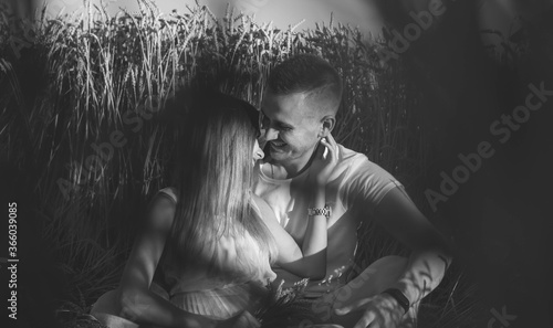  Couple sitting in a wheat field black and white photo