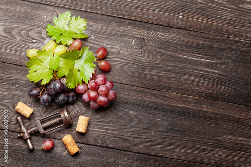 Various grapes, wine corks and corkscrew