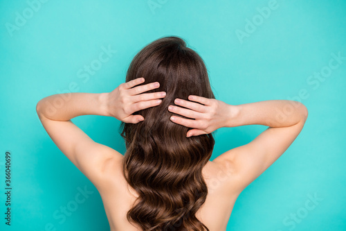 Closeup back rear behind view photo of beautiful lady curly long hairstyle touch hands perfect long curls styling preparing date nude shoulders isolated bright teal color background