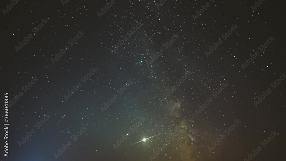 Night Starry Sky With Glowing Stars. Bright Glow Of Planets Saturn and Jupiter In Sky Among The Milky Way Galaxy Stars. Sky In Lights Of Sunset Dawn. 4K Timelapse Night Starry Sky With Glowing Stars. Bright Glow Of Planets Saturn and Jupiter In Sky Among The Milky Way Galaxy Stars. Sky In Lights Of Sunset Dawn. 4K Timelapse