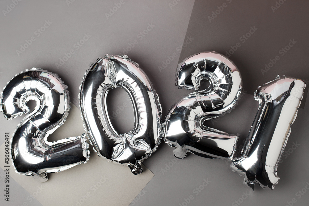 Christmas New Year 2021 numbers Silver Air balloons on gray. Celebration, seasonal holiday creative background, flat lay, banner for site, party decoration Christmas New Year 2021 numbers Silver Air balloons on gray. Celebration, seasonal holiday creative background, flat lay, banner for site, party decoration