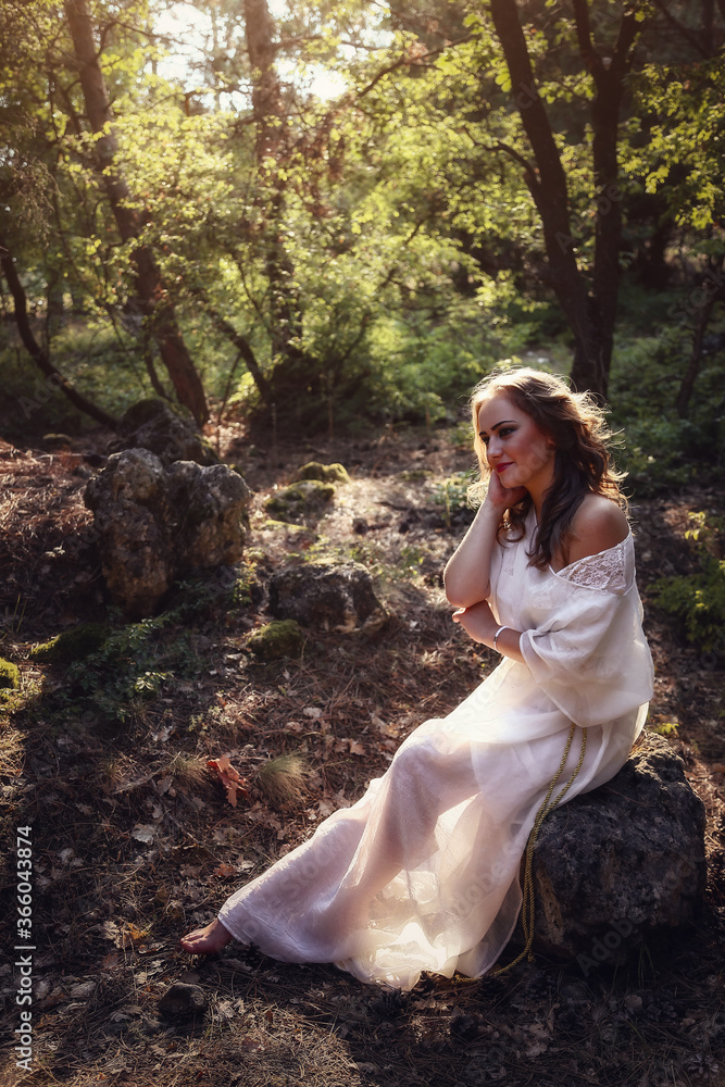 Beautiful mystery gothic woman in long white dress in autumn forest. Beautiful mystery gothic woman in long white dress in autumn forest.