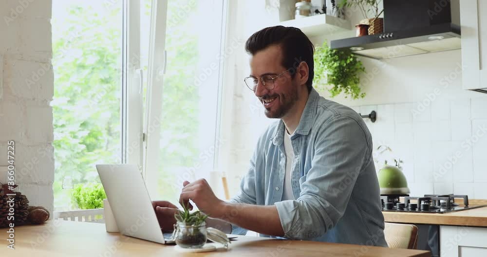 Handsome guy wear eyeglasses using laptop chatting in social network with friend, blogger comment give feedback communicates with subscribers. Freelance remote job, carefree weekend online fun concept Handsome guy wear eyeglasses using laptop chatting in social network with friend, blogger comment give feedback communicates with subscribers. Freelance remote job, carefree weekend online fun concept