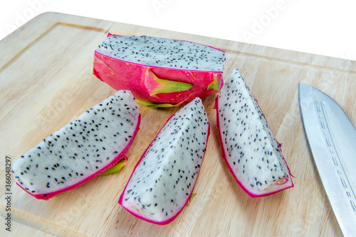Pink Dragon fruit slice with knife.