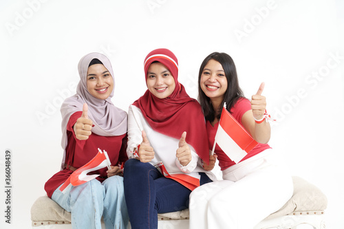 happy indonesian woman with flag celebrating independence day showing thumb up photo