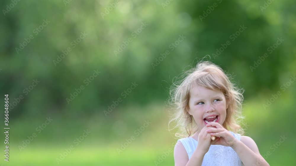 Little Cute Girl in White Summer Dress Enjoying Delicious Ice Cream. Kid with Ice Cream in the City Park. summer family lifestyle. Childhood Little Cute Girl in White Summer Dress Enjoying Delicious Ice Cream. Kid with Ice Cream in the City Park. summer family lifestyle. Childhood