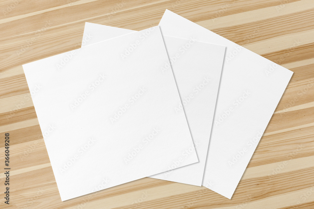3 Blank Square Flyers lying on shiny wooden desk clean 3 Blank Square Flyers lying on shiny wooden desk clean