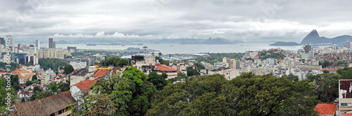 Rio de Janeiro, Brazil: panoramic view East from the Ruins Park in Santa Teresa, with sugarloaf mountain to the right and Santos Dumont airport and Niteroi bridge left.