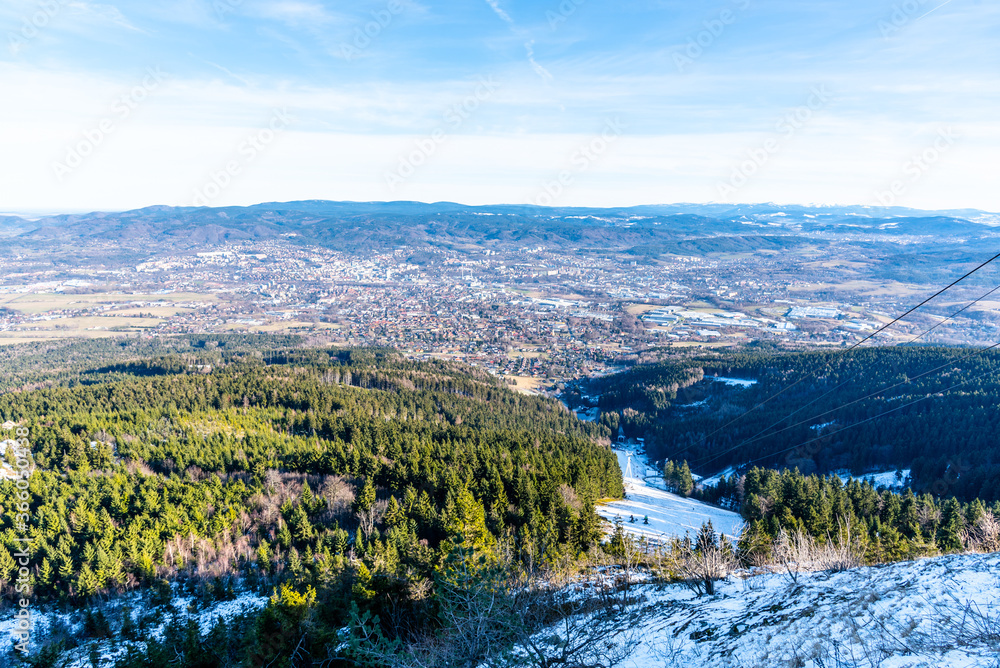 Fototapeta Scenic view of Liberec and surrounding mountains on sunny winter day. Lookout from Jested Mountain, Czech Republic