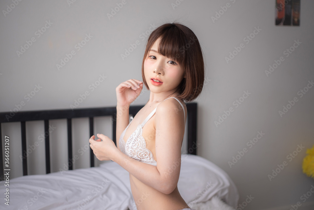 Bikini. Asian women wearing bikinis, posing in a studio room.