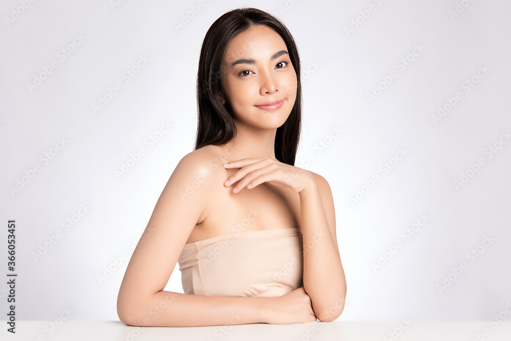 Beauty face. Smiling asian woman touching healthy skin portrait. Beautiful happy girl model with fresh glowing hydrated facial skin and natural makeup on white background, Beauty face. Smiling asian woman touching healthy skin portrait. Beautiful happy girl model with fresh glowing hydrated facial skin and natural makeup on white background,