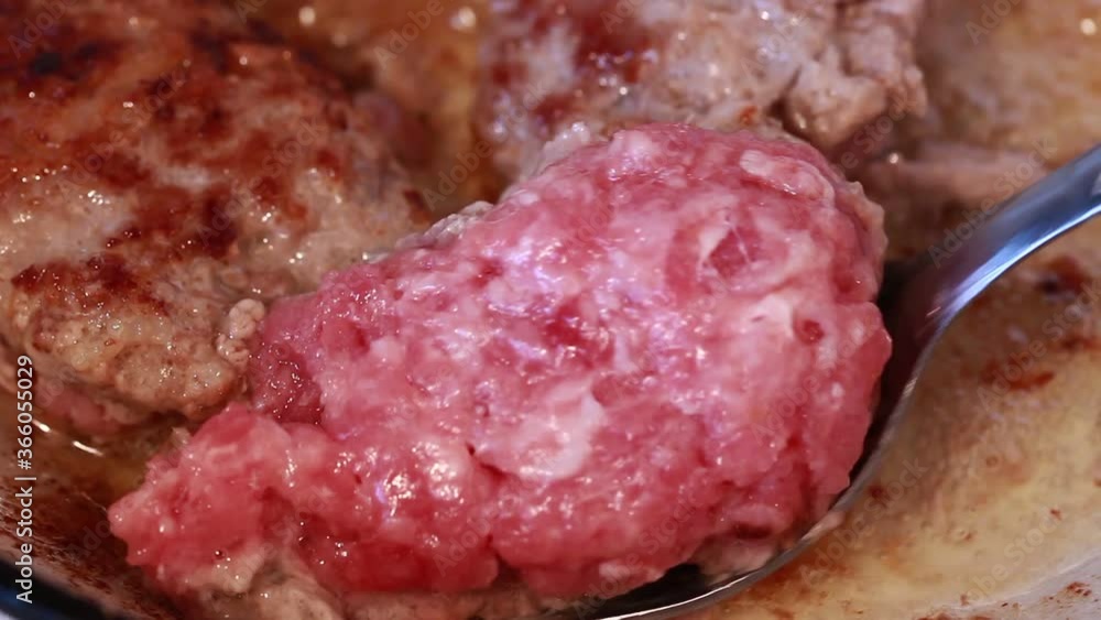 Minced meat is fried in a pan in oil. Minced meat is fried in a pan in oil.