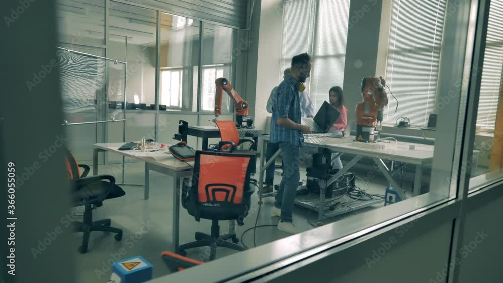 Group of developers are communicating in a robotics laboratory Group of developers are communicating in a robotics laboratory