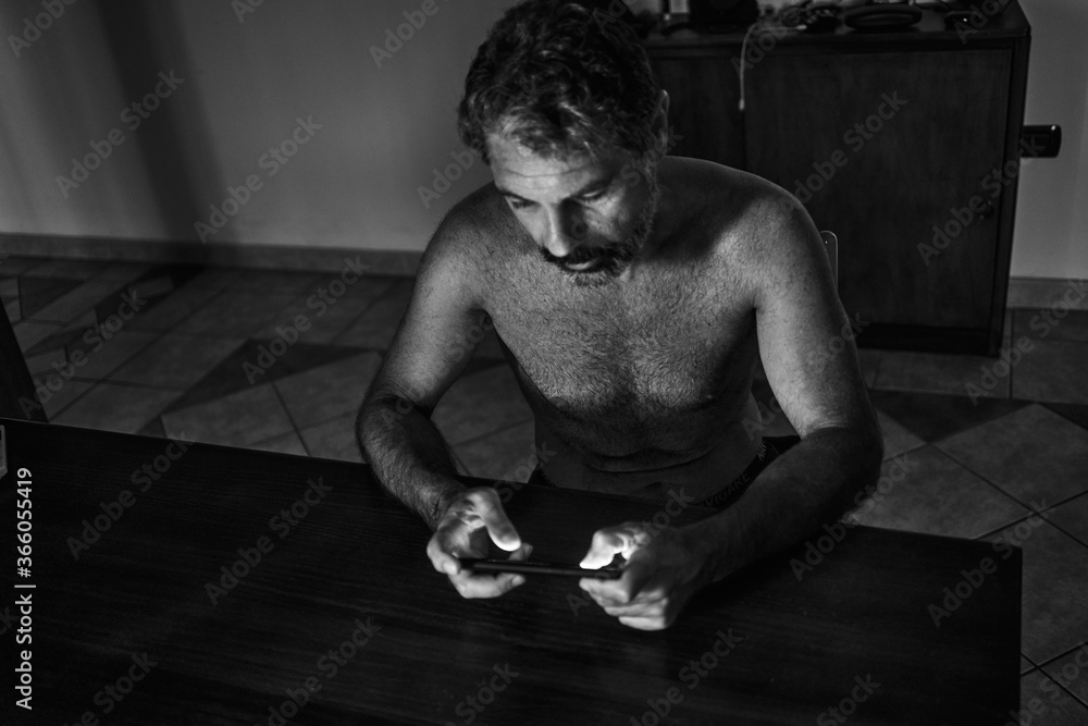 portrait of a man looking at the smmartphone
