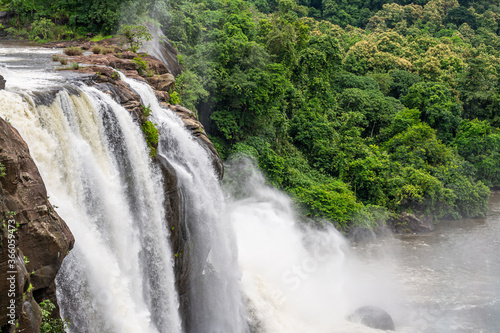 Beautiful nature view during Mansoon time with full filled water fall and green forest from the famous tourist place in Kerala, India called Athirappalli, Vaazhachaal