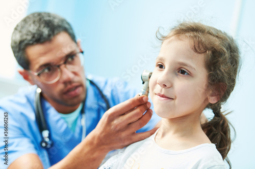 ENT medical examination of little girl by african doctor