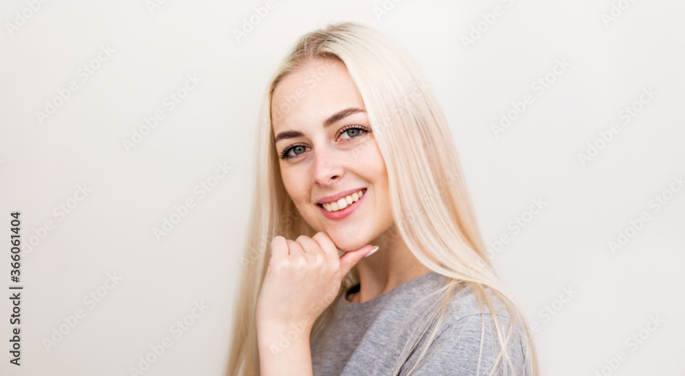 Pretty smiling joyfully female with fair hair, dressed casually, looking with satisfaction at camera, being happy. Studio shot of good-looking beautiful woman Pretty smiling joyfully female with fair hair, dressed casually, looking with satisfaction at camera, being happy. Studio shot of good-looking beautiful woman