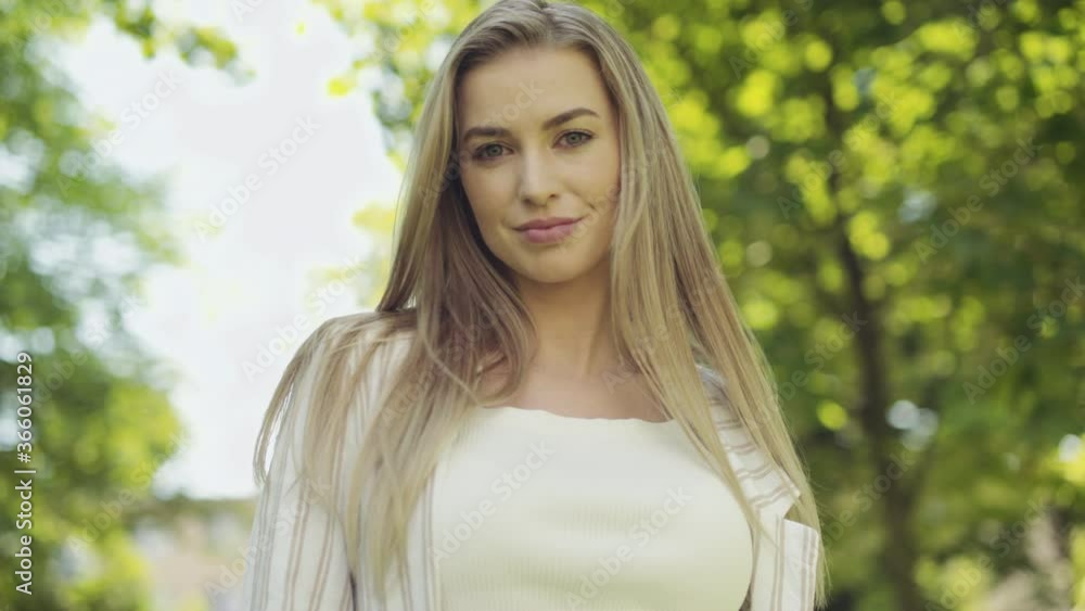 Portrait of beautiful young blonde woman in a city. Portrait of beautiful young blonde woman in a city.