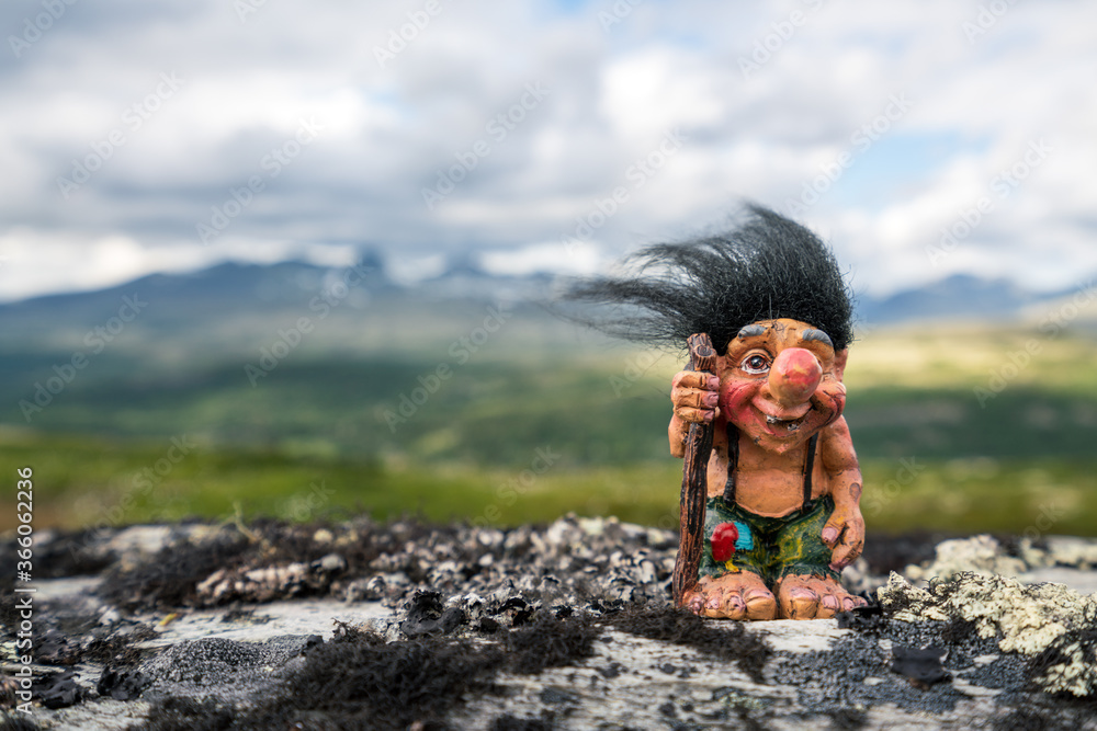 Funny norwegian troll figure with big nose and walking stick outdoors in  the mountains. Hair standing up because of windy conditions. Stock-bilde |  Adobe Stock