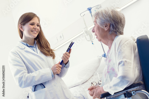 Woman doctor consulting with a senior patient