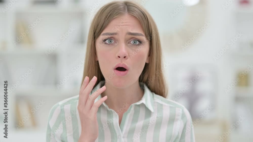 Portrait of Disappointed Young Woman reacting to Loss 