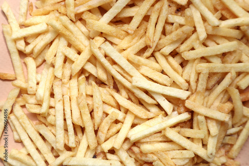 Lots of french fries on a beige background