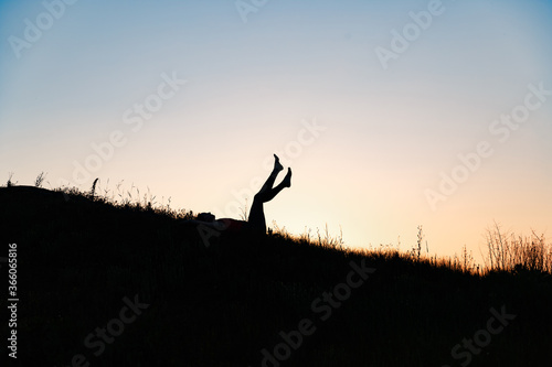 girl doing yoga in nature at sunset