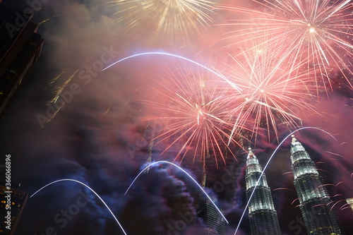 Kuala Lumpur, Malaysia – January 1, 2020: Colourful Fireworks spark during New Year at the Kuala Lumpur City. The image contains certain grain or noise and soft focus.