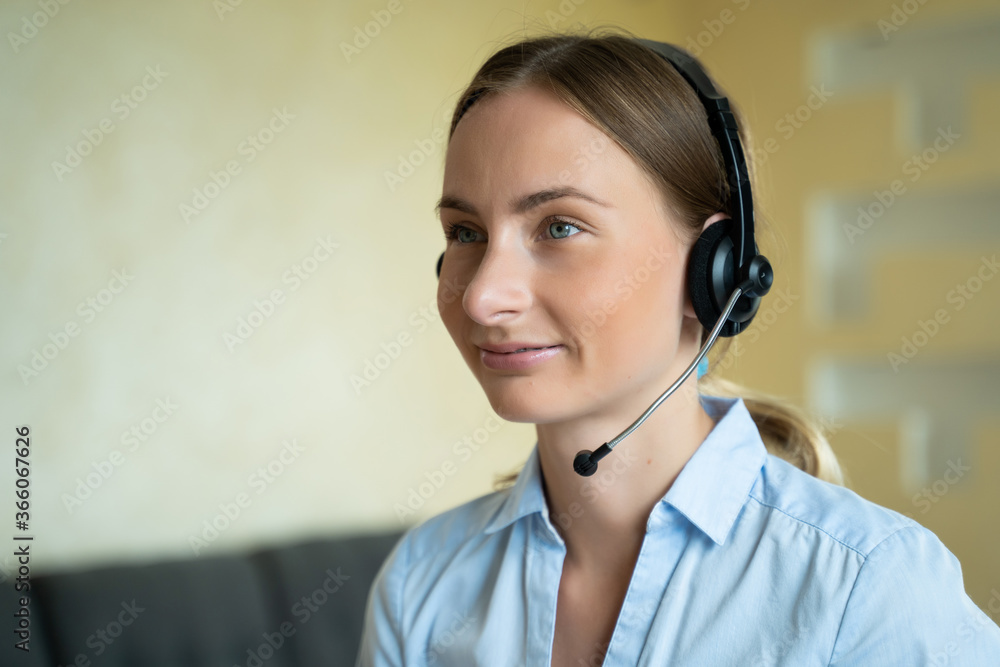 Businesswoman talking on the phone while working on her computer at the office. Call сenter agent working on hotline Businesswoman talking on the phone while working on her computer at the office. Call сenter agent working on hotline