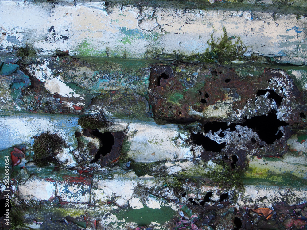 Fototapeta premium close up of an old rusted peeling steel with layers of peeling silver and green paint