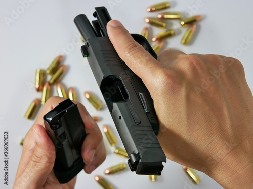 Fotografía Short guns and ammunition placed on white background
