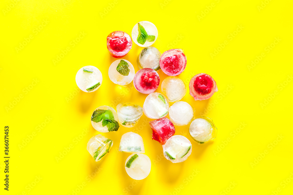 Fototapeta premium Berries and mint in ice cubes top view