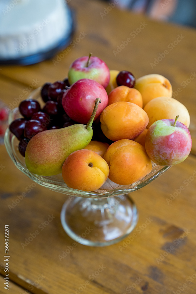 glass vase with summer fruit. glass vase with summer fruit.