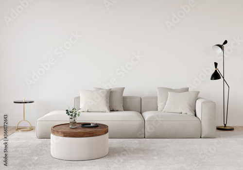 Living room in beige tones with a sofa, a floor lamp, a wooden table and a gold side table photo