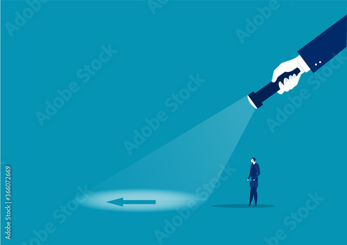 businessman looking direct flash with big hand holds a flashlight to Vision direction. Search direction. 
