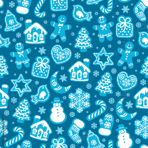 Christmas and New Year seamless pattern of traditional gingerbread cookies and snowflakes on dark blue background