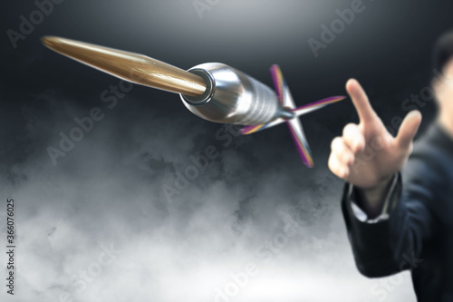 Man throwing dart to an objective photo
