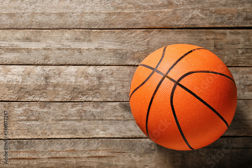 Ball for playing basketball game on wooden background © Pixel-Shot