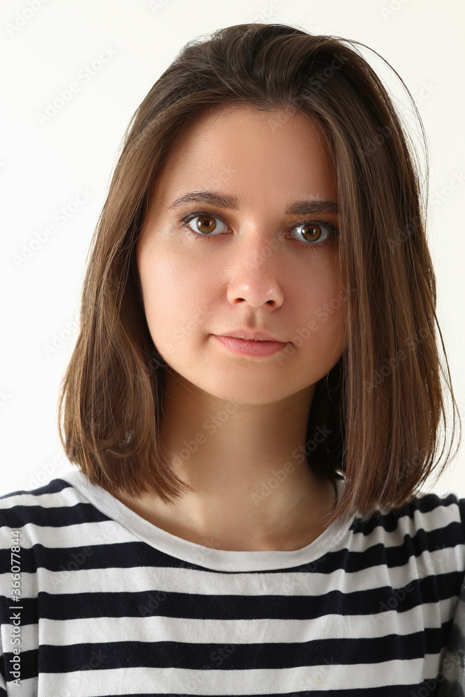 Portrait of cute tranquil female in stripped t-shirt with casual look isolated on white background Portrait of cute tranquil female in stripped t-shirt with casual look isolated on white background