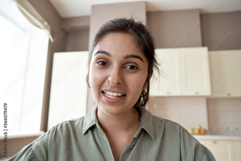 Young indian woman online teacher, counselor, remote tutor or job applicant speaking looking at web cam giving online training, virtual class lesson, video call interview. Webcam view face headshot. Young indian woman online teacher, counselor, remote tutor or job applicant speaking looking at web cam giving online training, virtual class lesson, video call interview. Webcam view face headshot.
