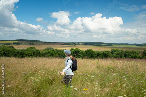 Young Tourist, Walking In Meadow In Russia In Summer.