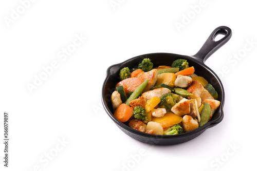 Stir fry chicken with vegetables on iron pan isolated on white background. Copy space