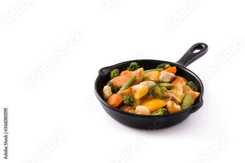 Stir fry chicken with vegetables on iron pan isolated on white background